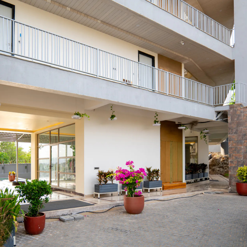 Grand Exterior Entrance at Villa Miraan – Large Group Villa with Pool Udaipur Exterior facade and paved driveway of a multi-story large group villa with pool Udaipur.