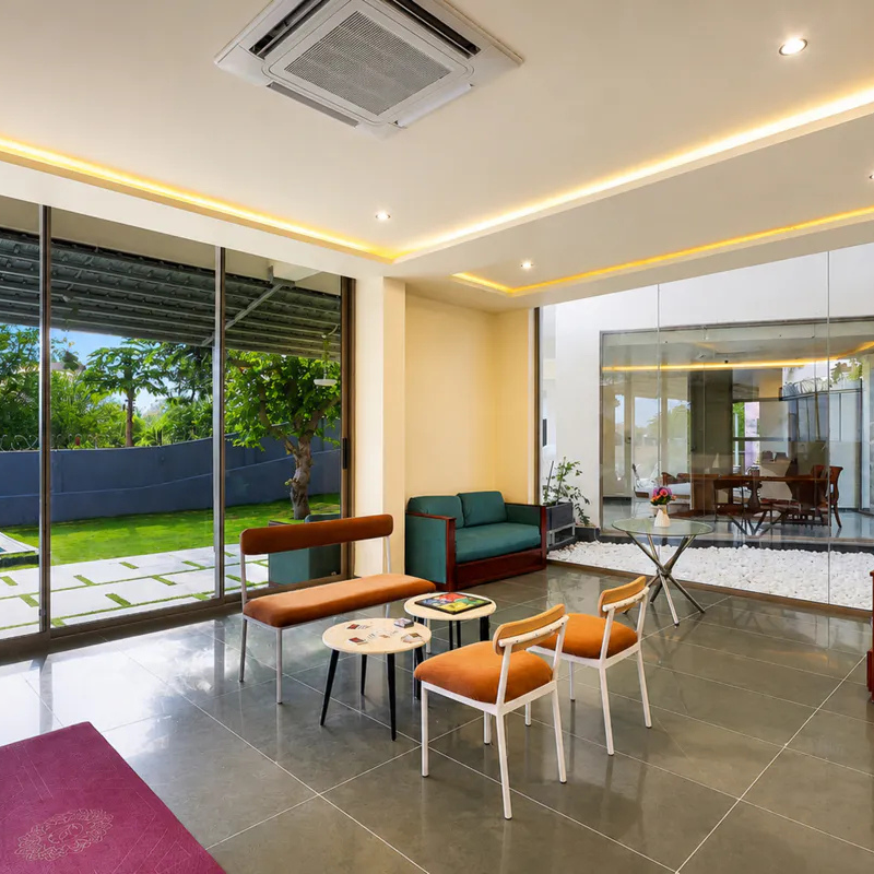 Sunlit Gathering Space at Villa Miraan – 9 BHK Villa Udaipur Bright indoor common area with colorful modern furniture inside a 9 BHK villa Udaipur.